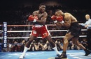 Mike Tyson dodges a punch from Frank Bruno in a WBC title fight