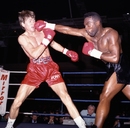Nigel Benn (right) lands a punch against Nicky Piper during their WBC title fight