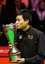 Ding Junhui celebrates with the trophy after defeating John Higgins in the 2009 UK Championship