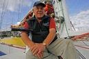 Tony Bullimore posing on his catamaran the Doha 2006 
