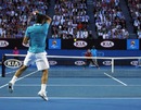 Roger Federer puts everything into a forehand against Lleyton Hewitt