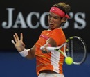 Rafael Nadal climbs into a forehand against Andy Murray