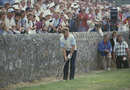 Tom Watson plays from near the wall at the 17th