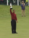 Tiger Woods shows his trophy to the crowd