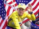 Lance Armstrong rides with the American flag in tow