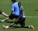 Mario Balotelli stretches with team-mates during a team training session