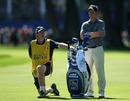 Luke Donald assesses his options while his caddie limbers up