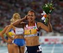 Jessica Ennis poses with flowers after snatching the heptathlon gold