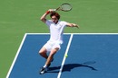 Ernests Gulbis returns a forehand to Lukas Lacko