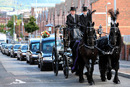 Alex Higgins' funeral procession makes its way through Belfast