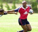 Jonah Lomu fends off a tackle