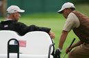Tiger Woods talks to Corey Pavin
