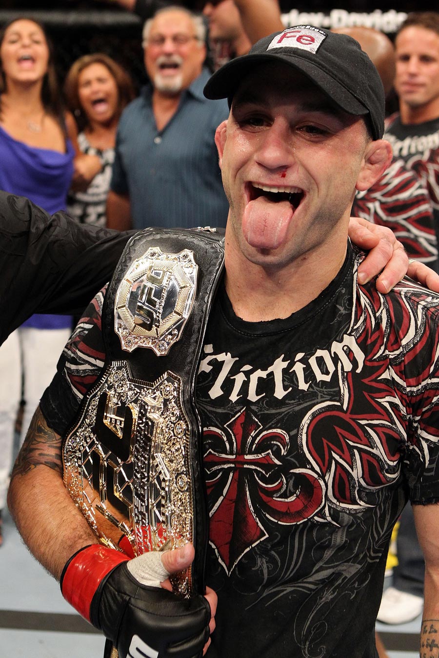 Frank Edgar celebrates with the belt after defeating BJ Penn
