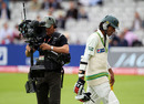 Mohammad Amir walks off after being bowled for a duck