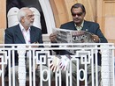 Pakistan's cricket manager Yawar Saeed reads a copy of the News of the World newspaper