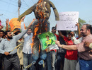Pakistani cricket fans hold a burning effigy of national cricket captain Salman Butt 