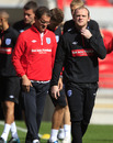Fabio Capello walks behind Wayne Rooney