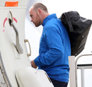 Wayne Rooney boards a plane at Luton Airport 