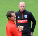 Fabio Capello points out instructions with Wayne Rooney looking on