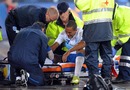 Theo Walcott receives help after going down injured