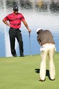 Tiger Woods looks on at Phil Mickelson putts