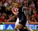 Ryan Shawcross tussles for possession with Gabriel Agbonlahor