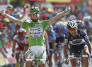 Mark Cavendish celebrates as he crosses the line to win stage 18