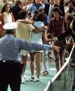 Bobby Riggs comes off court defeated by Billie Jean-King