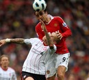 Dimitar Berbatov competes for the ball with Martin Skrtel