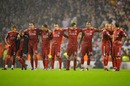 Liverpool players watch the penalty shoot-out
