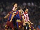 Carlos Puyol and Sergio Busquets go up for a header
