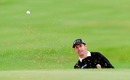 Padraig Harrington looks on with intent from the bunker