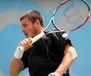 Josh Goodall plays a forehand against Gilles Muller