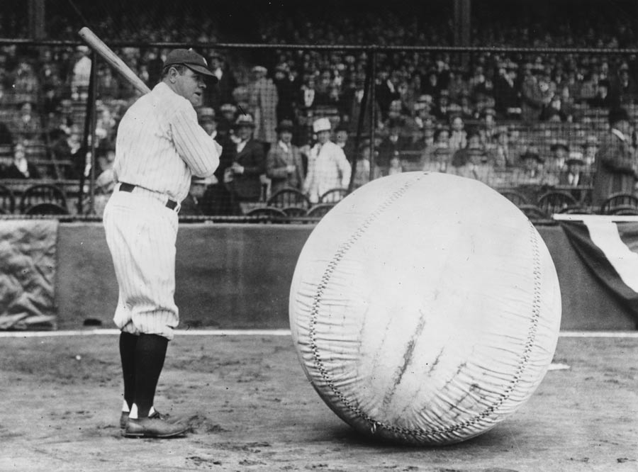 Babe Ruth takes a swipe at an enormous ball