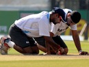 Amit Mishra and Harbhajan Singh have a closer look at the pitch