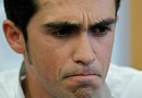 Alberto Contador looks grim faced at a press conference 