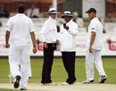 The umpires check for bad light