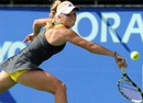 Caroline Wozniacki returns a shot in the final