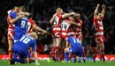 Wigan celebrate as St Helens players contemplate defeat