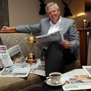 Colin Montgomerie poses with the Ryder Cup and the morning papers