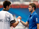Novak Djokovic shakes hands with Gilles Simon