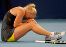 Caroline Wozniacki clutches her knee in pain