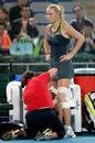 Caroline Wozniacki receives treatment on her knee