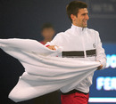 Novak Djokovic plays with a towel