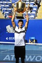 Novak Djokovic lifts his trophy above his head