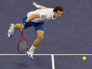 Andy Murray stoops to hit a return