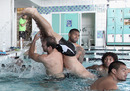 Frank-Paul Nuuausala and Jason Nightingale dump team-mate Issac Luke into the pool 