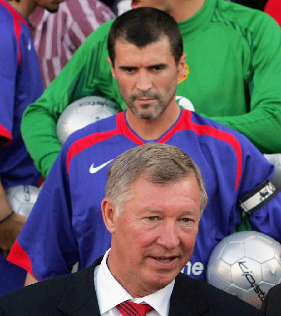 Roy Keane stares at Sir Alex Ferguson