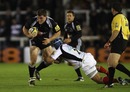 Mark Wilson of Newcastle is held by Schalk Brits of Saracens