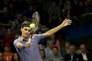 Roger Federer plays a return against Stanislas Wawrinka